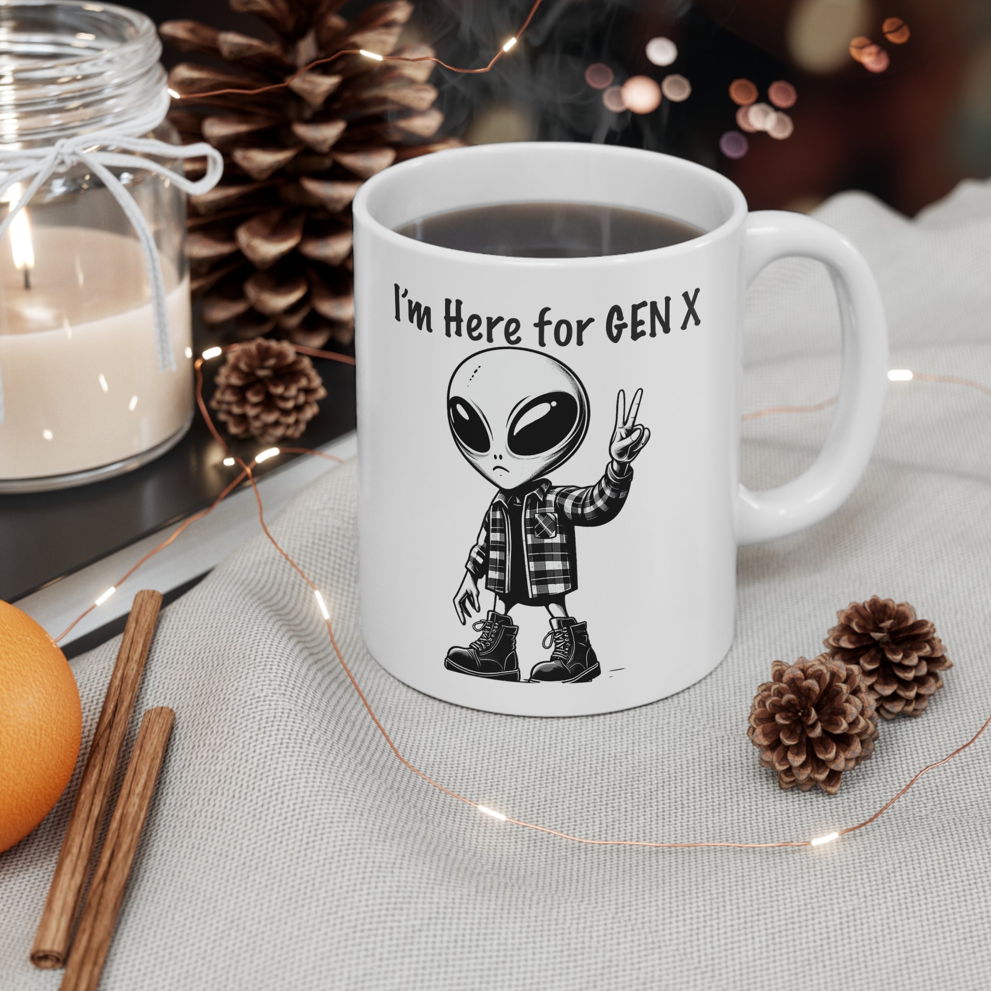  this mug that features an alien with combat boots and a flannel shirt, flashing a peace sign, saying “I’m here for Gen X”.