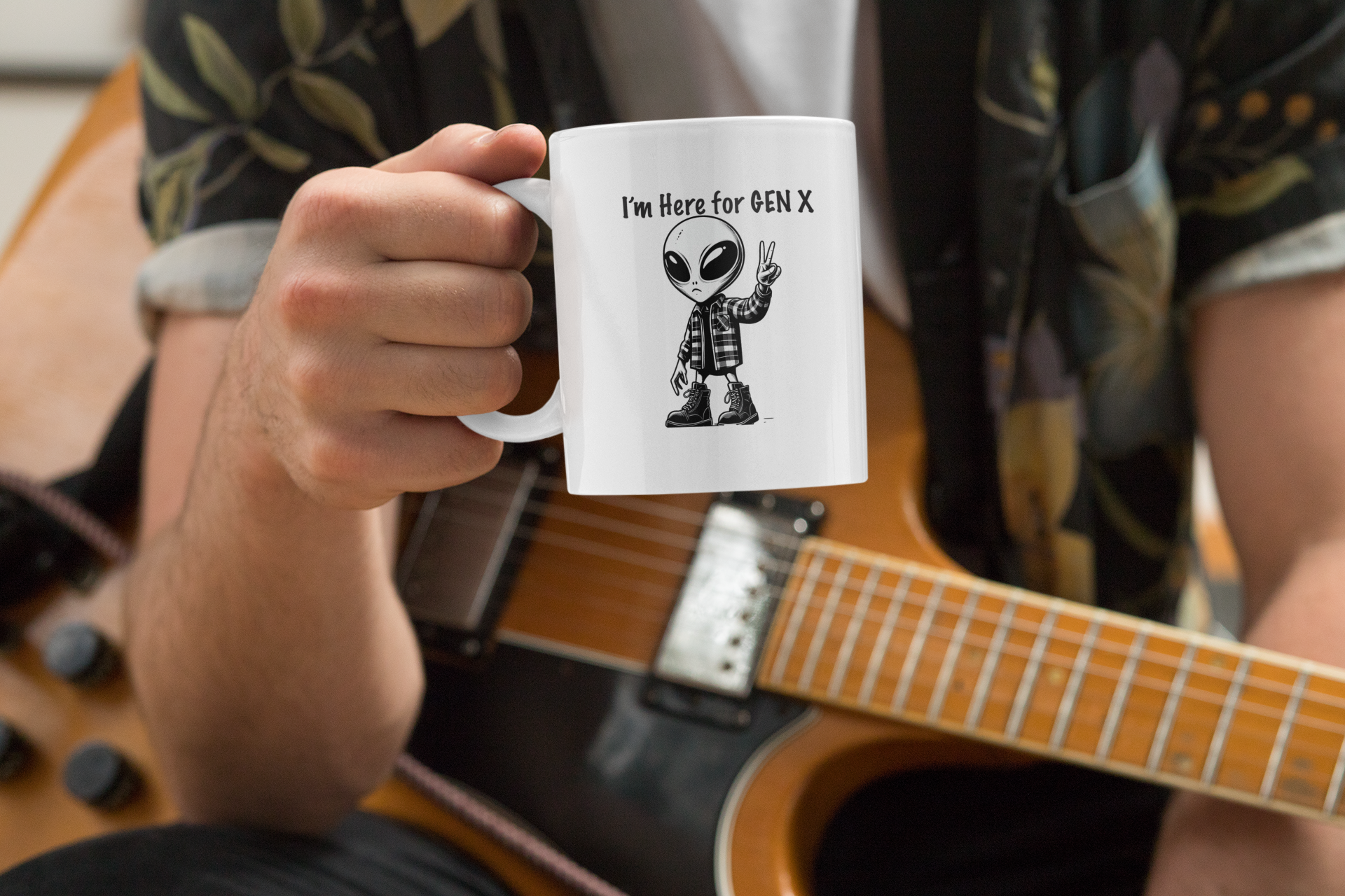  This mug that features an alien with combat boots and a flannel shirt, flashing a peace sign, saying “I’m here for Gen X”.